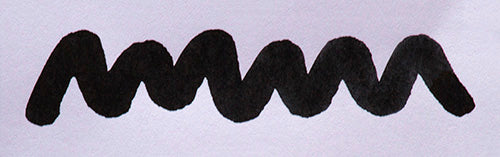 Wavy black line on a white background. Diamine Jet Black fountain pen ink colour swatch.