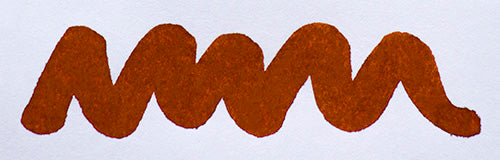 Wavy brown line on a white background. Diamine Ochre fountain pen ink colour swatch.