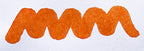 Wavy orange line on a white background. Diamine Autumn Oak fountain pen ink colour swatch.