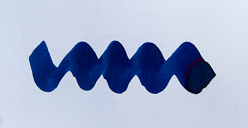 Wavy blue line on a white background. Diamine Polar Glow fountain pen ink colour swatch.