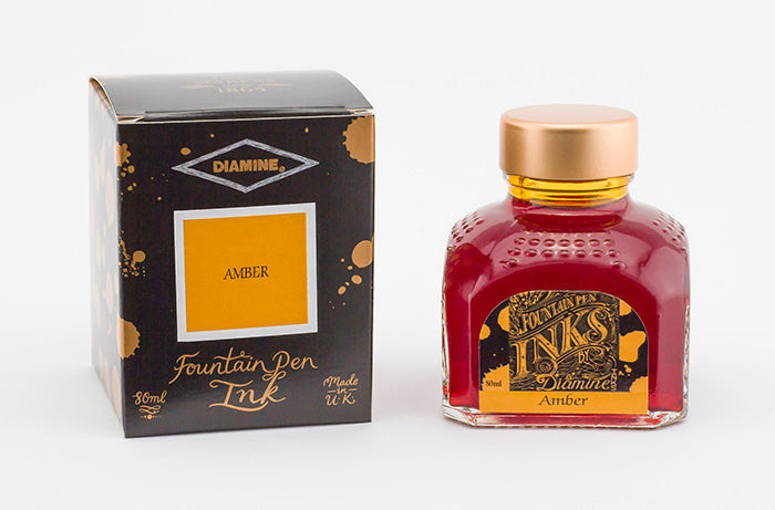 Diamine Amber fountain pen ink bottle and packaging on a white background.