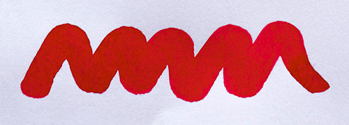 Wavy pink line on a white background. Diamine Scarlet fountain pen ink colour swatch.