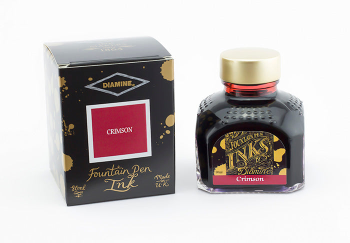 Diamine Crimson fountain pen ink bottle and packaging on a white background.