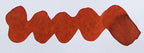Wavy orange red line on a white background. Diamine Red Robin fountain pen ink colour swatch.