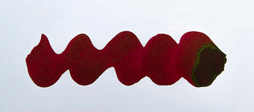 Wavy burgundy line on a white background. Diamine Noel fountain pen ink colour swatch.