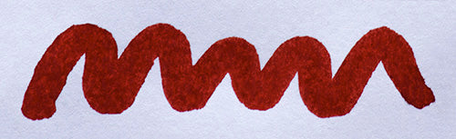 Wavy red line on a white background. Diamine Monaco Red fountain pen ink colour swatch.
