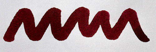 Wavy burgundy line on a white background. Diamine Burgundy Royale fountain pen ink colour swatch.