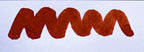 Wavy brown line on a white background. Diamine Terracotta fountain pen ink colour swatch.