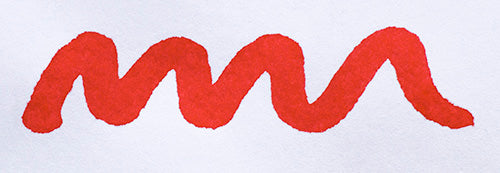 Wavy red line on a white background. Diamine Passion Red fountain pen ink colour swatch.