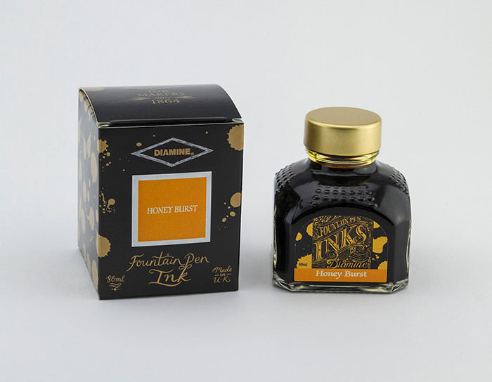 Diamine Honey Burst fountain pen ink bottle and packaging on a white background.