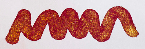 Wavy red line on a white background. Diamine Red Lustre fountain pen ink colour swatch.