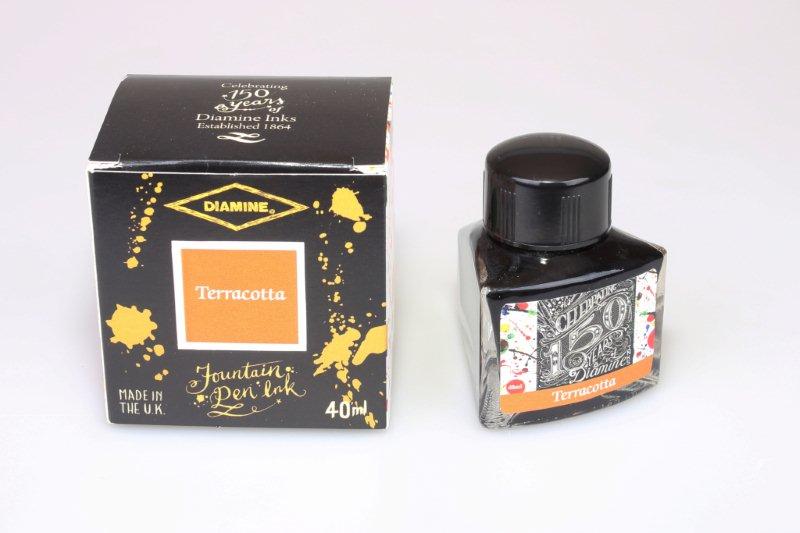 Diamine Terracotta fountain pen ink bottle and packaging on a white background.