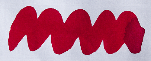 Wavy red line on a white background. Diamine Wax Seal fountain pen ink colour swatch.