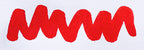 Wavy red line on a white background. Diamine Poppy Red fountain pen ink colour swatch.