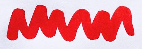 Wavy red line on a white background. Diamine Poppy Red fountain pen ink colour swatch.