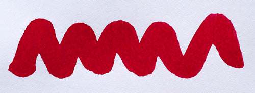 Wavy red line on a white background. Diamine Ruby fountain pen ink colour swatch.