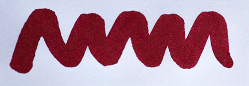 Wavy red line on a white background. Diamine Burgundy Rose fountain pen ink colour swatch.