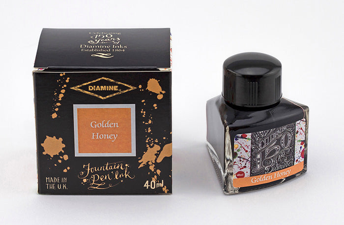 Diamine Golden Honey fountain pen ink bottle and packaging on a white background.