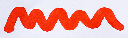 Wavy red line on a white background. Diamine Wild Strawberry fountain pen ink colour swatch.