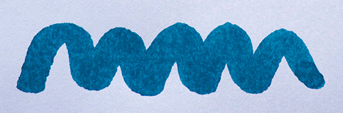 Wavy blue line on a white background. Diamine Misty Blue fountain pen ink colour swatch.