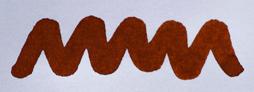Wavy orange brown line on a white background. Diamine Ancient Copper fountain pen ink colour swatch.