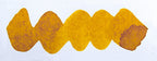 Wavy yellow brown line on a white background. Diamine Candlelight  fountain pen ink colour swatch.